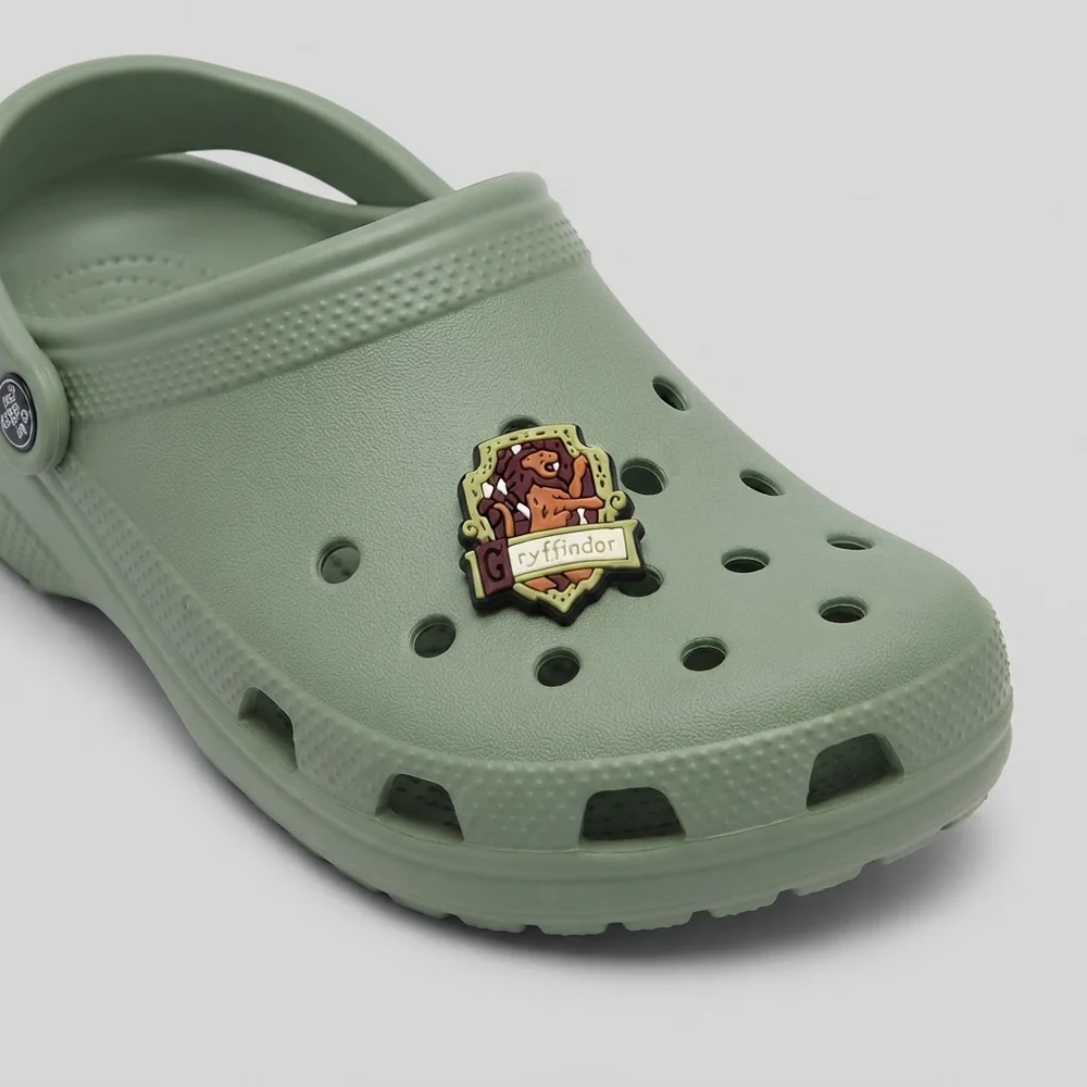 Charm blason Gryffondor clipsé sur une Crocs vert sauge