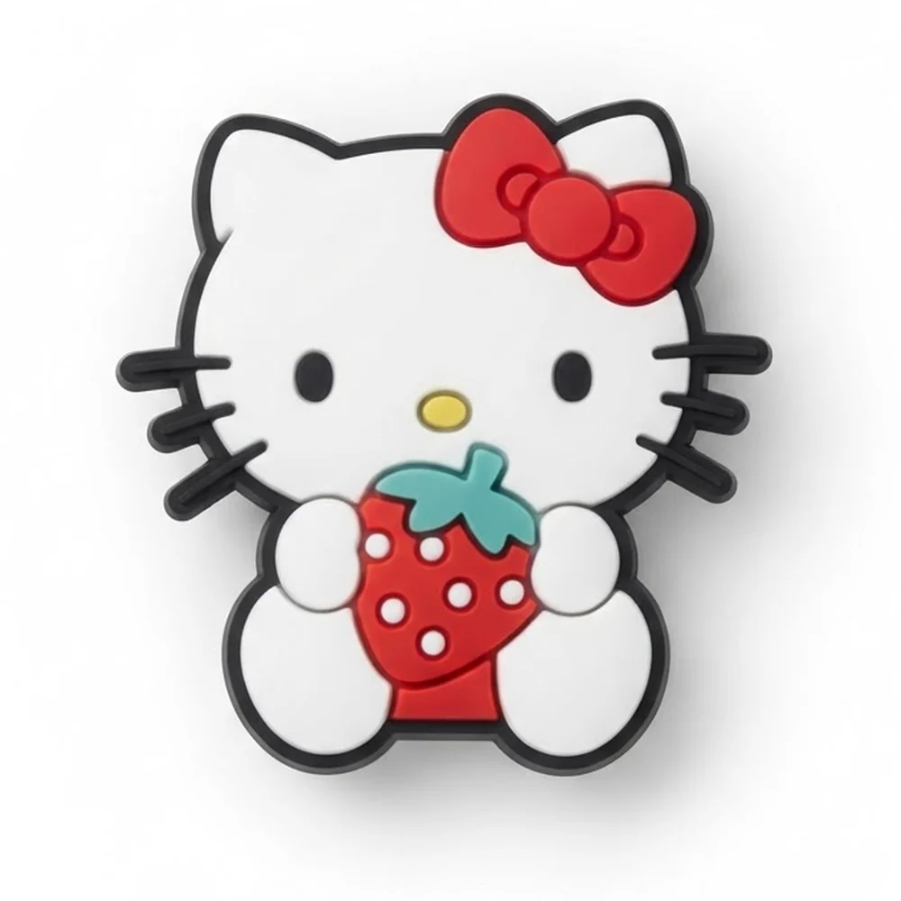 Jibbitz Hello Kitty assise tenant une fraise rouge à pépins blancs, nœud rouge