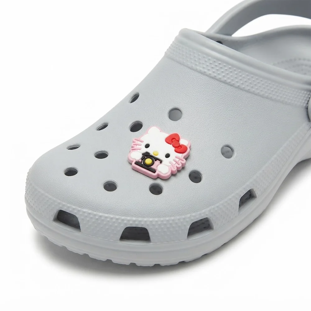 Jibbitz Hello Kitty photographe clipsé sur une Crocs grise