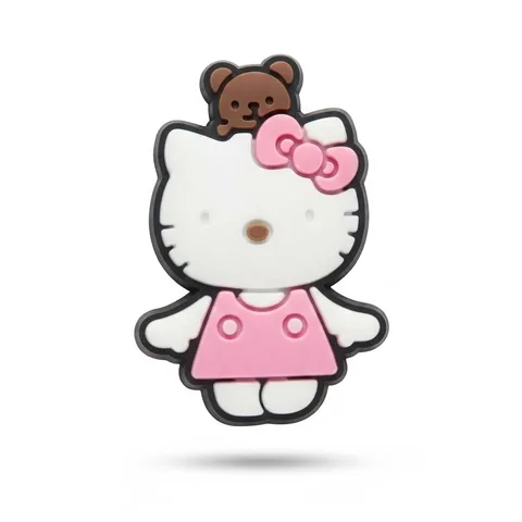 Jibbitz Hello Kitty debout en robe rose, ourson marron perché sur la tête